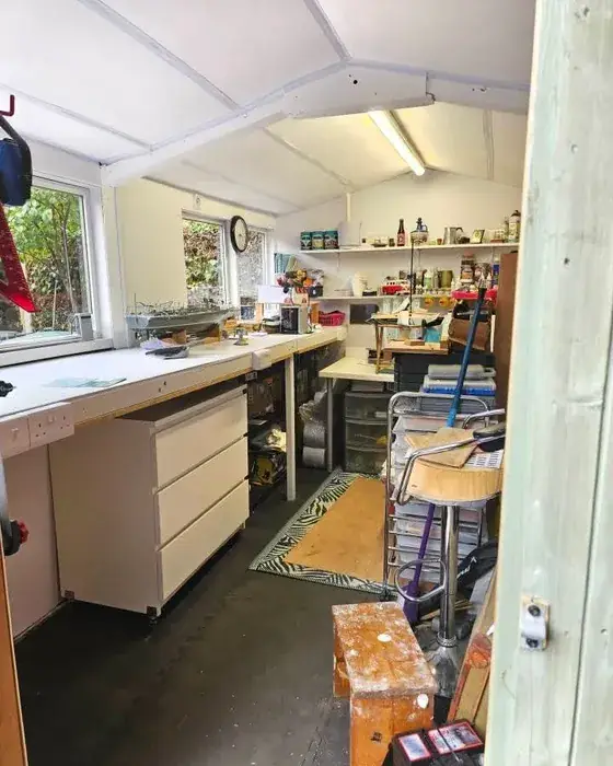 Garden shed workshop with a white ceiling, an LED batten light and double sockets above the workbench, wired by CAB Electrical in the Wirral